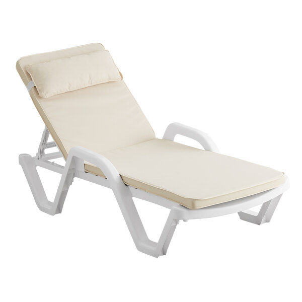 A white chaise lounge chair with a beige cushion and pillow.
