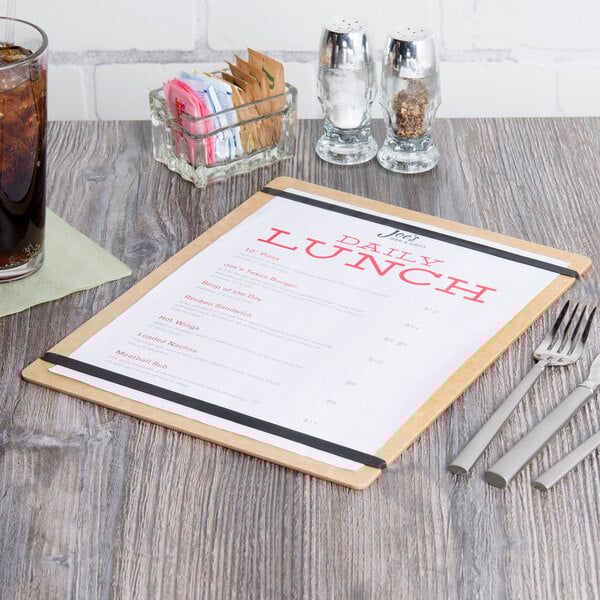 A natural wood menu board with a menu on a table.