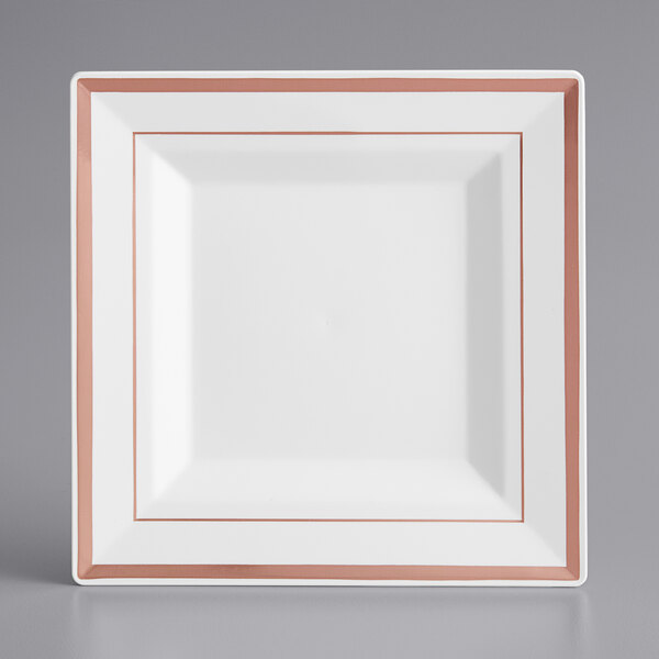 A white square plate with rose gold bands on the border.