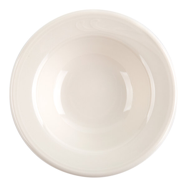 A top-down view of a small, round, ivory-colored ceramic dish with smooth, slightly curved sides.
