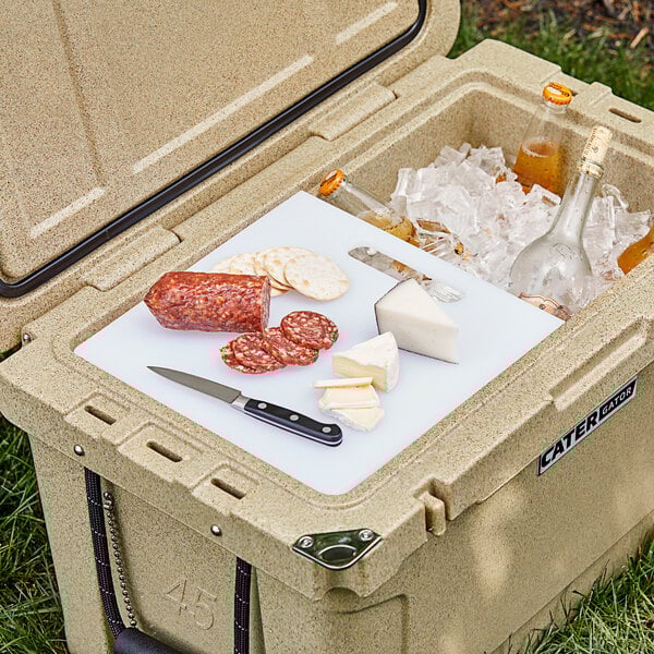 a bottle of beer and a knife on a cutting board