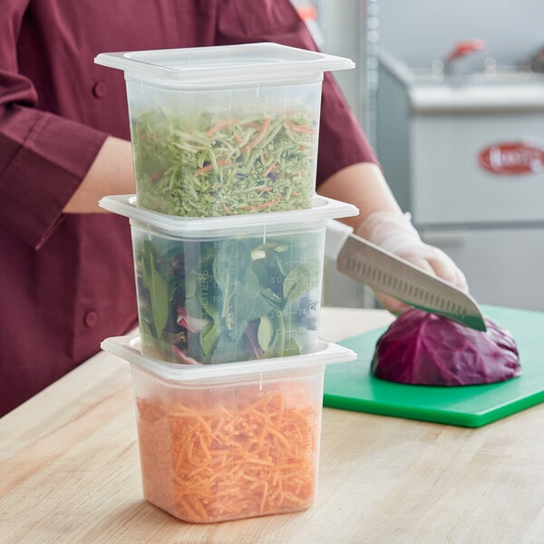 A person cutting vegetables in a San Jamar translucent plastic food pan on a counter.