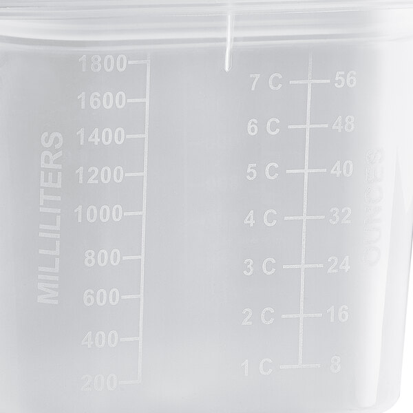 A translucent plastic food pan with measurements on it.