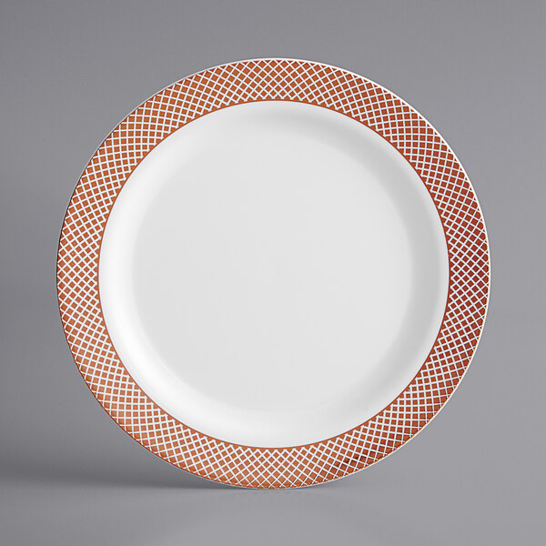 A white plastic plate with rose gold lattice design on the trim.