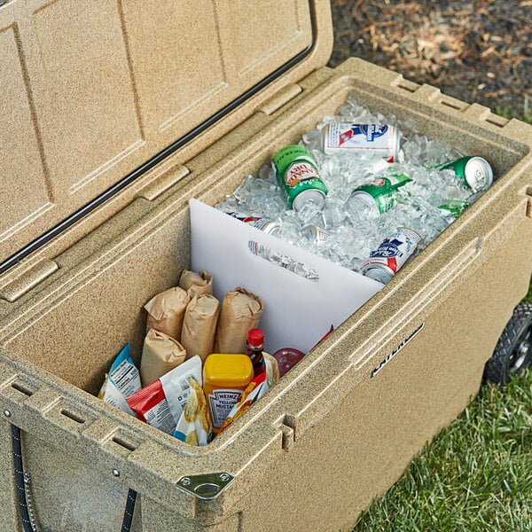 An open cooler filled with ice, various beverages in bottles and cans, and packaged food.