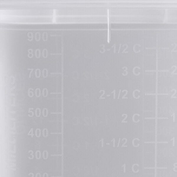 A close-up of a San Jamar translucent plastic food pan with measurements on it.