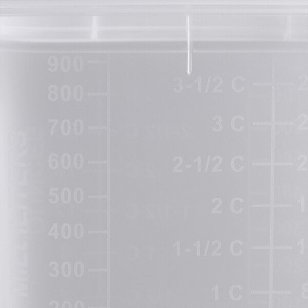 A translucent plastic San Jamar food pan with measurements on the side.