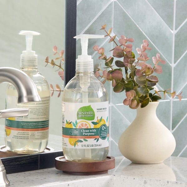 A bottle of Seventh Generation Purely Clean Mandarin Orange & Grapefruit hand soap with a pump dispenser placed on a bathroom counter.