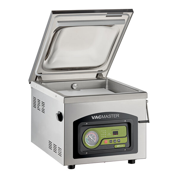 A stainless steel tabletop vacuum packaging machine with a digital control panel and an open chamber lid.