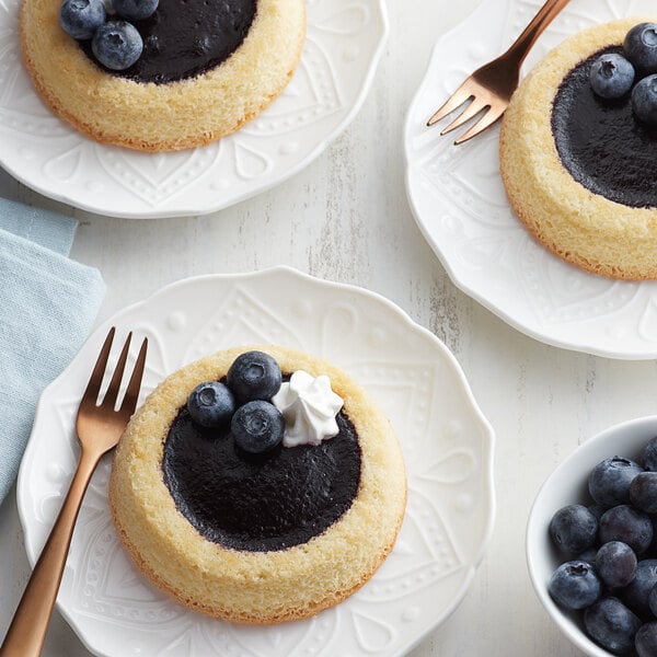 A group of desserts with Les Vergers Boiron blueberry puree, blueberries, and whipped cream.