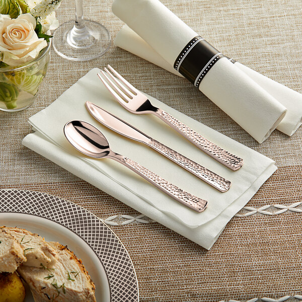 Hammersmith rose gold plastic cutlery on a napkin with a Visions linen-feel napkin.