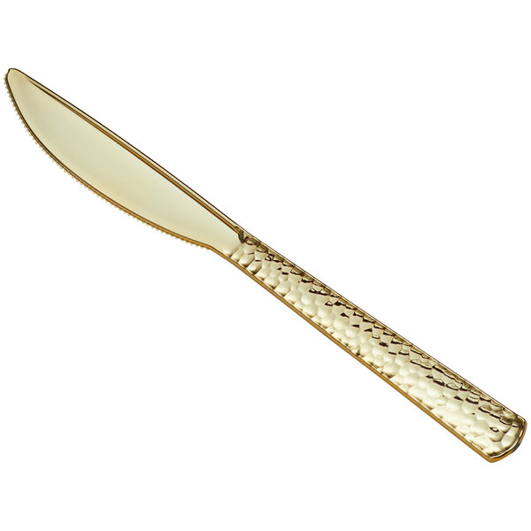 A Visions Hammersmith gold plastic knife with a handle.