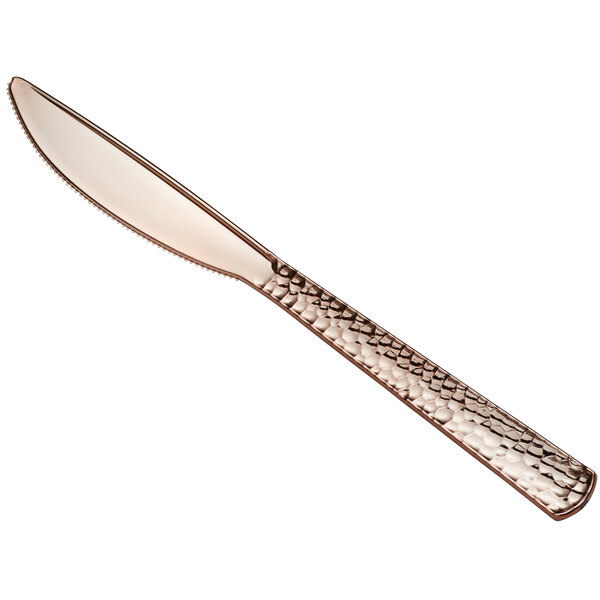 A Visions rose gold plastic knife with a textured handle.