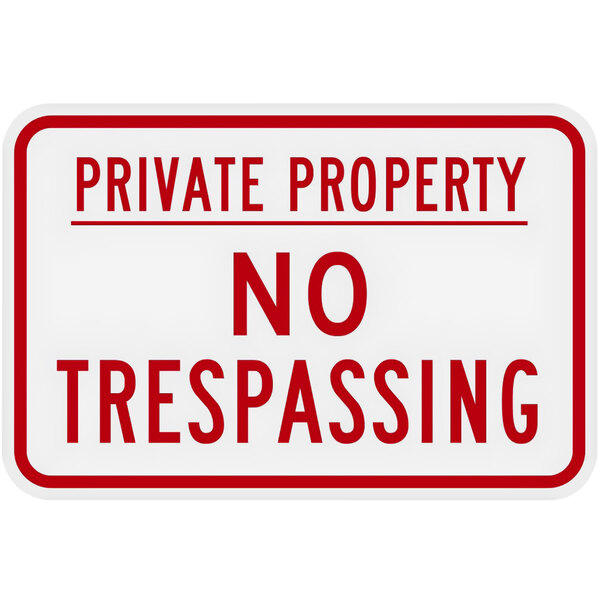 A white aluminum sign with red text that says "Private Property / No Trespassing"