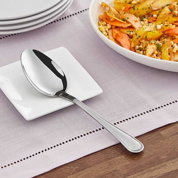 A plate with a spoon on it and food.