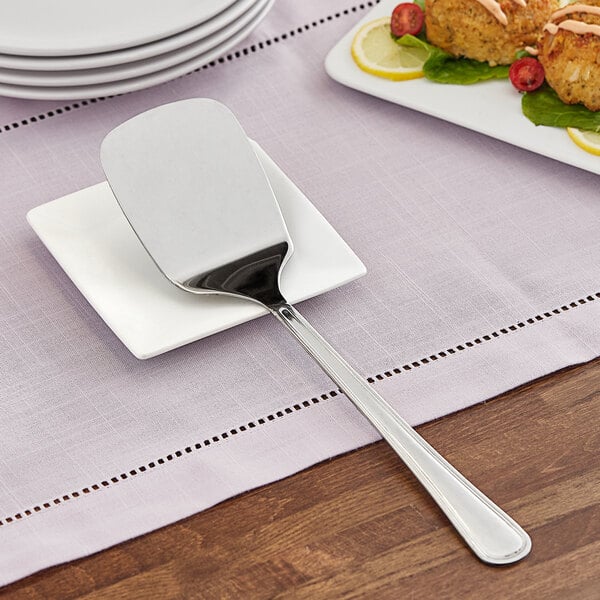 A GET stainless steel spatula with a mirror finish on a plate.