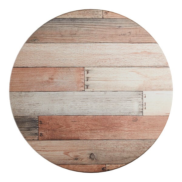 A round table top with a textured mixed plank wood finish.
