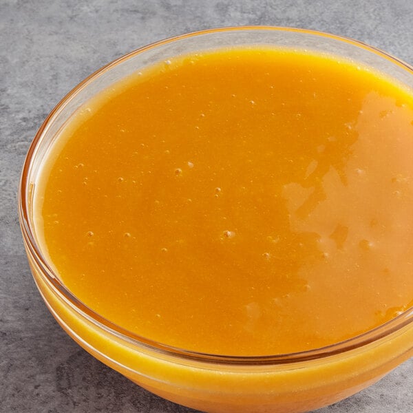 A bowl of Les Vergers Boiron apricot puree on a counter.