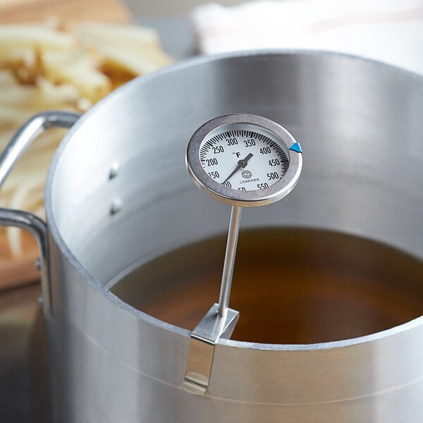 A Comark candy / deep fry thermometer in a pot of boiling liquid.