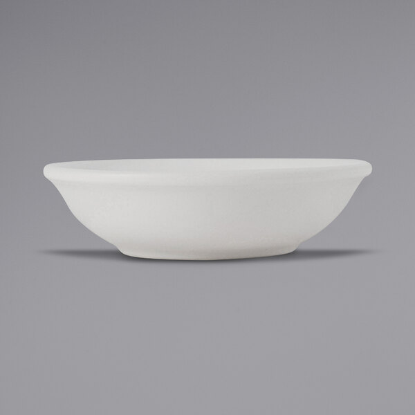 A close-up of a Tuxton TuxTrendz Zion matte white fruit dish.