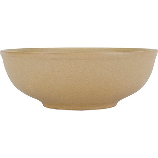 A close up of a Tuxton TuxTrendz Zion matte beige china menudo bowl.