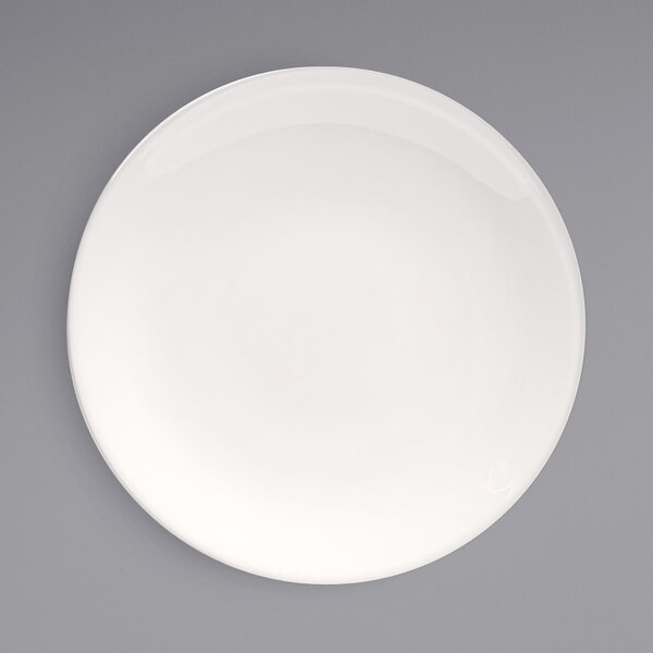 A Front of the House European white porcelain plate with a white rim on a gray surface.