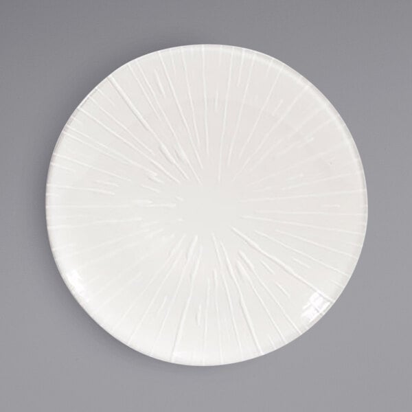 A Front of the House European white porcelain plate with an embossed rim design.