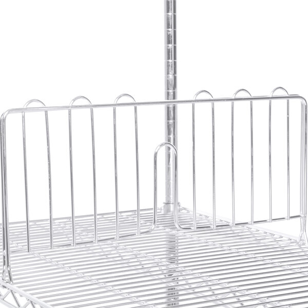 A stainless steel wire shelf divider on a metal shelf.