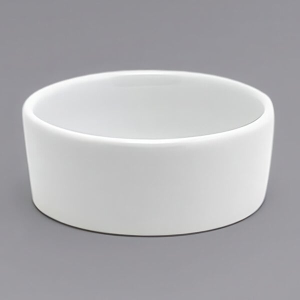 A white Front of the House Soho porcelain ramekin on a gray surface.