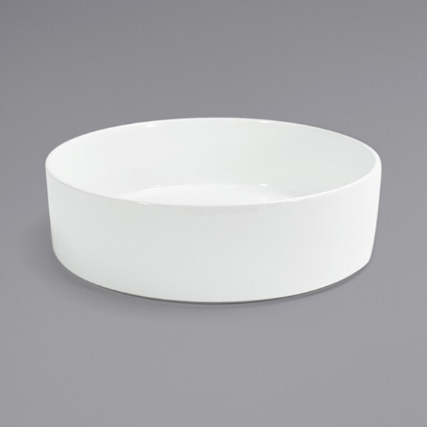 A Front of the House Soho bright white porcelain bowl on a gray surface.