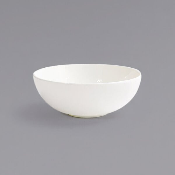 A Front of the House Catalyst European White porcelain bowl on a gray surface.