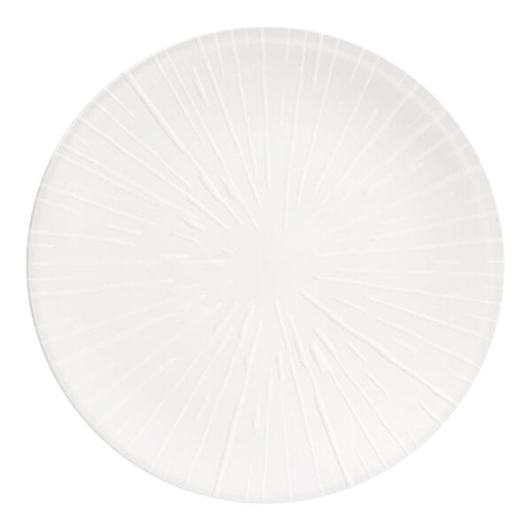 A round, white porcelain plate with an embossed spoke pattern.