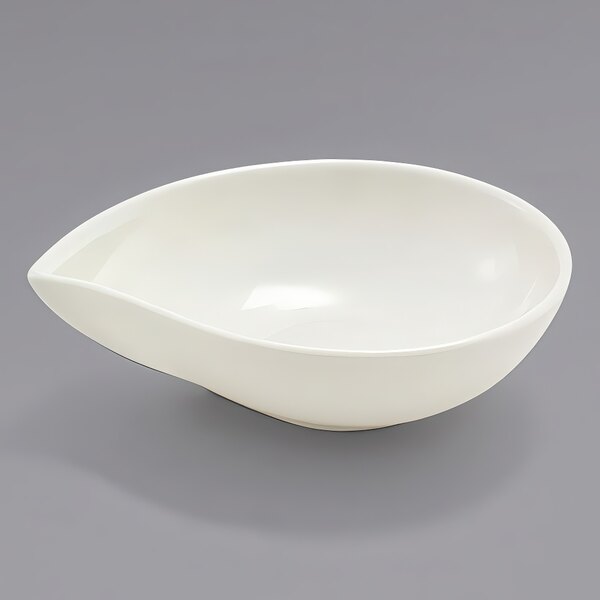 A white Front of the House European white teardrop ramekin on a gray surface.