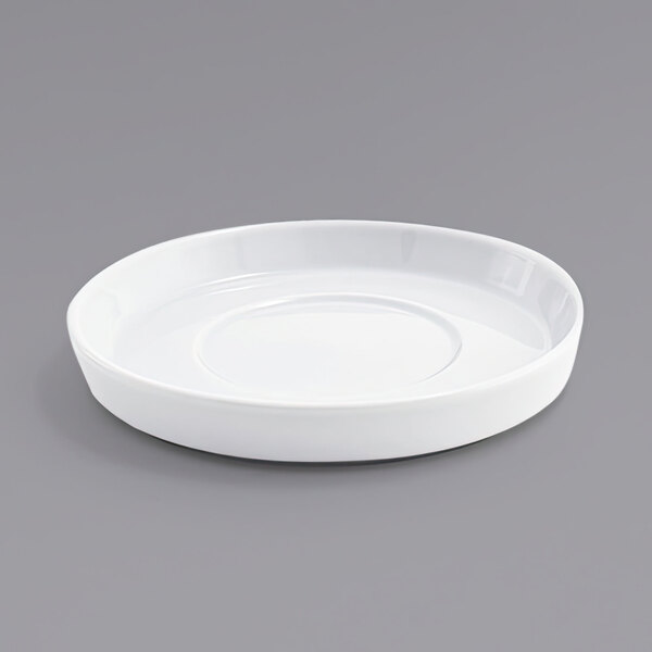 A white plate on a gray surface.