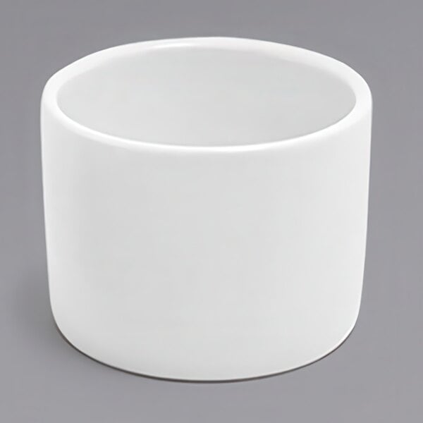 A white round porcelain ramekin on a white background.