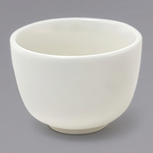 A close up of a Front of the House European white porcelain ramekin.