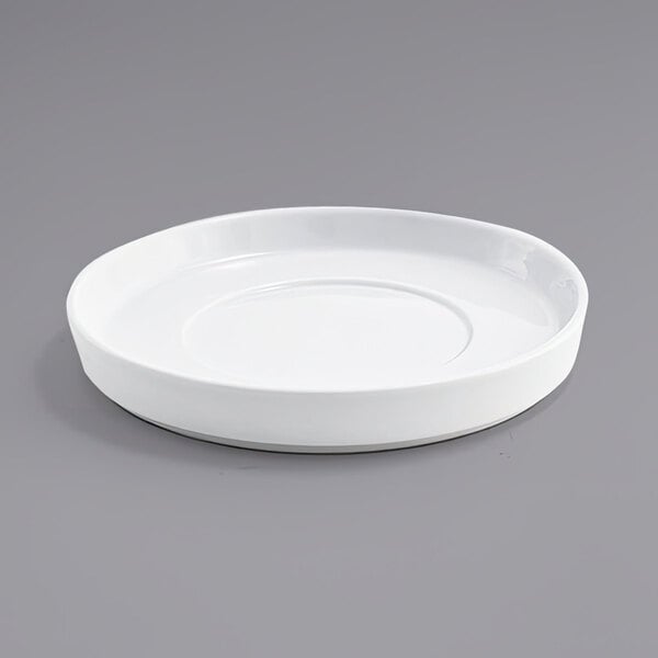 A white plate with a circular edge on a gray surface.