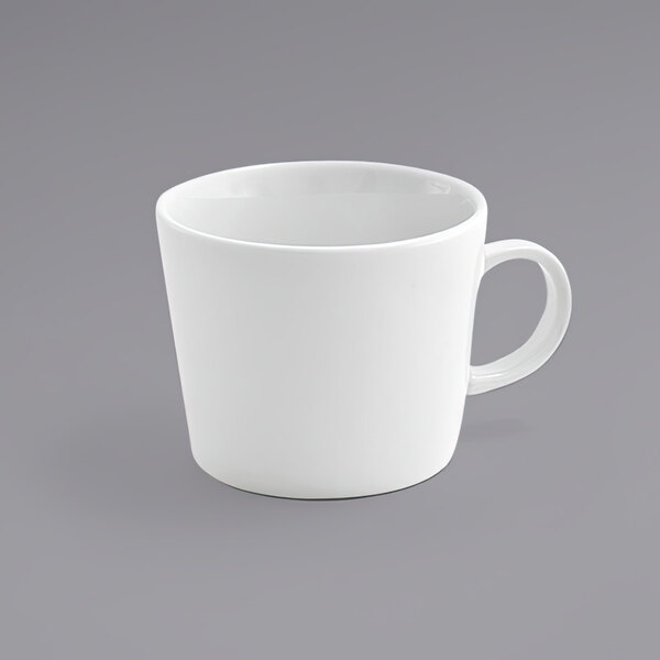 A close up of a Front of the House Soho bright white porcelain cup with a handle.