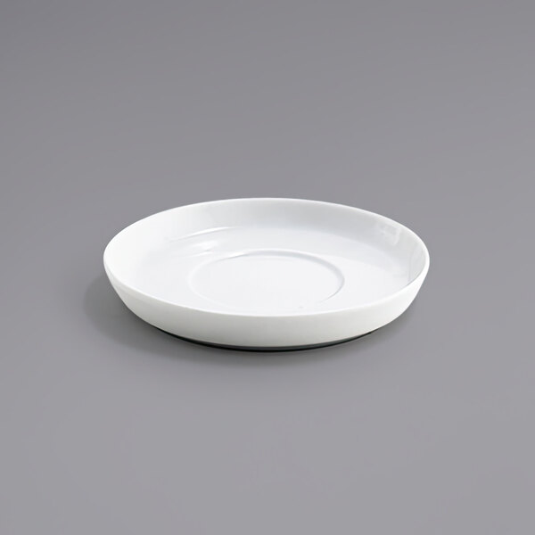 A white Front of the House Soho porcelain saucer on a surface.