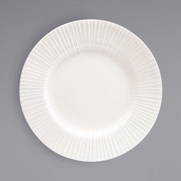 A white Front of the House Catalyst porcelain plate with a wavy pattern.