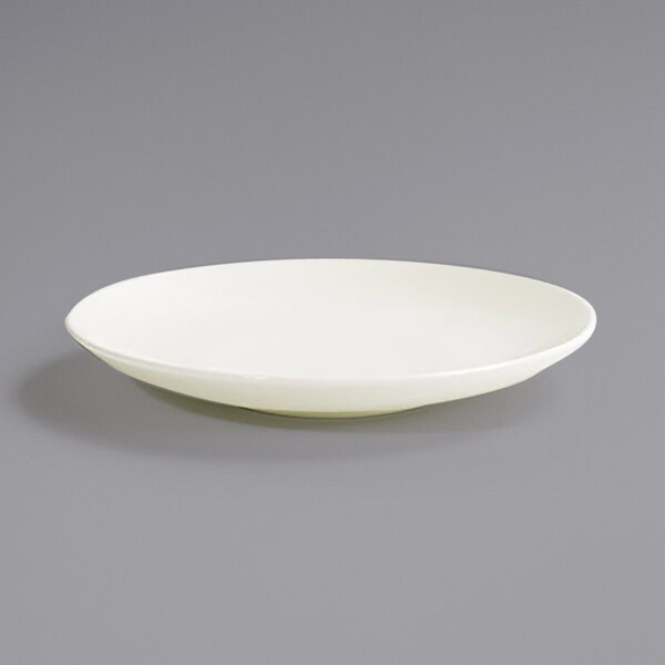 A Front of the House European White porcelain plate with a small rim on a gray surface.