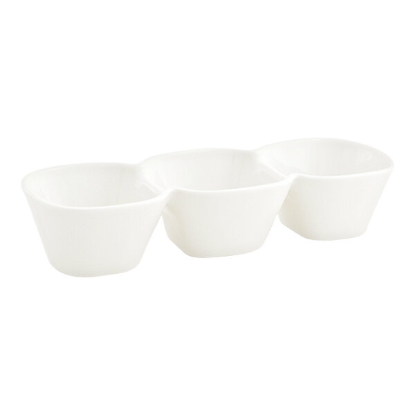 A white porcelain bowl with three connected compartments.