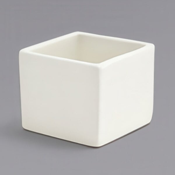 A Front of the House European white square porcelain ramekin.