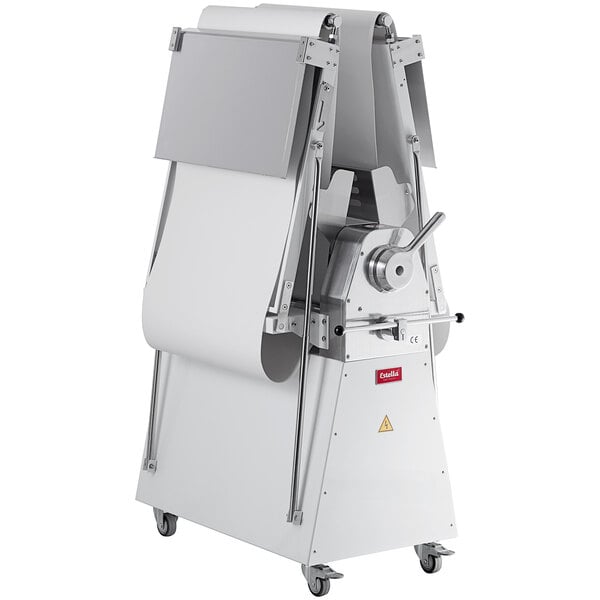 A large metal Estella floor dough sheeter with white cover on wheels.