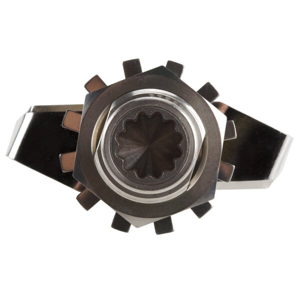 A close-up of a silver metal gear with a hole in it.