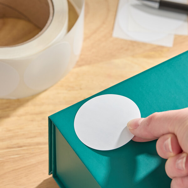 A roll of 2-inch white gloss paper permanent round inventory labels.