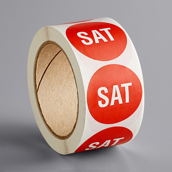 a roll of red and white stickers with white text