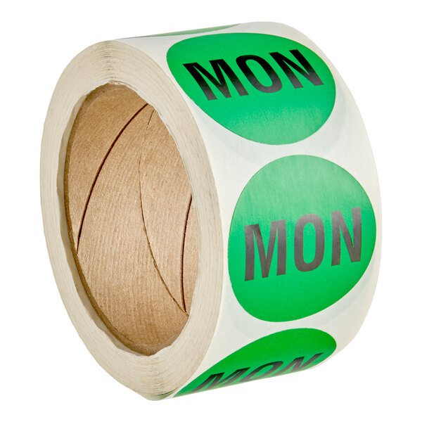 A roll of green circular labels with the word 'MON' printed in bold black letters.