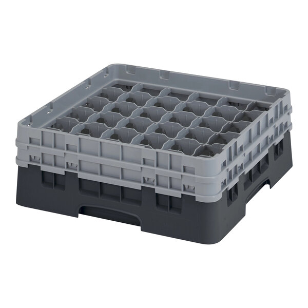 A black and grey plastic Cambro glass rack with compartments and extenders.