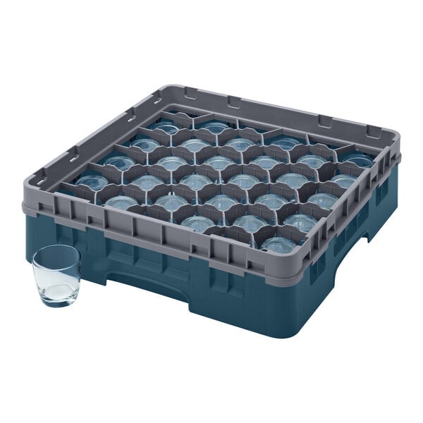 A teal plastic Cambro rack with many glass compartments inside.